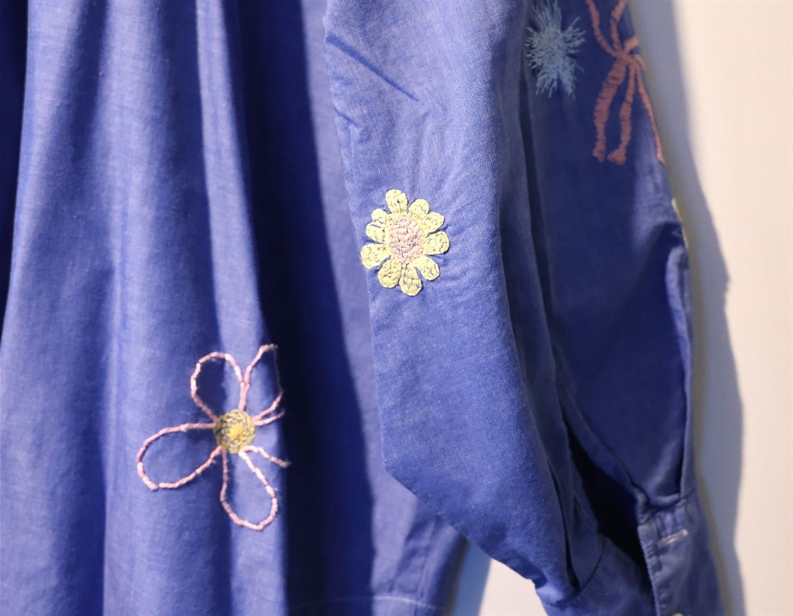 Image of embroidery on blue shirt