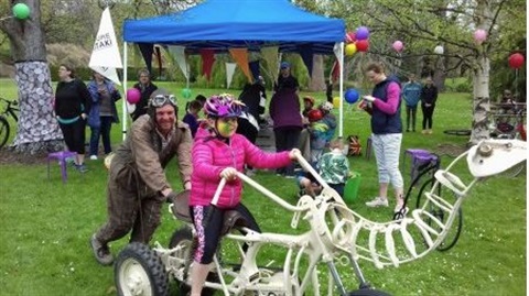 Dinosaur bones bike with a child riding it